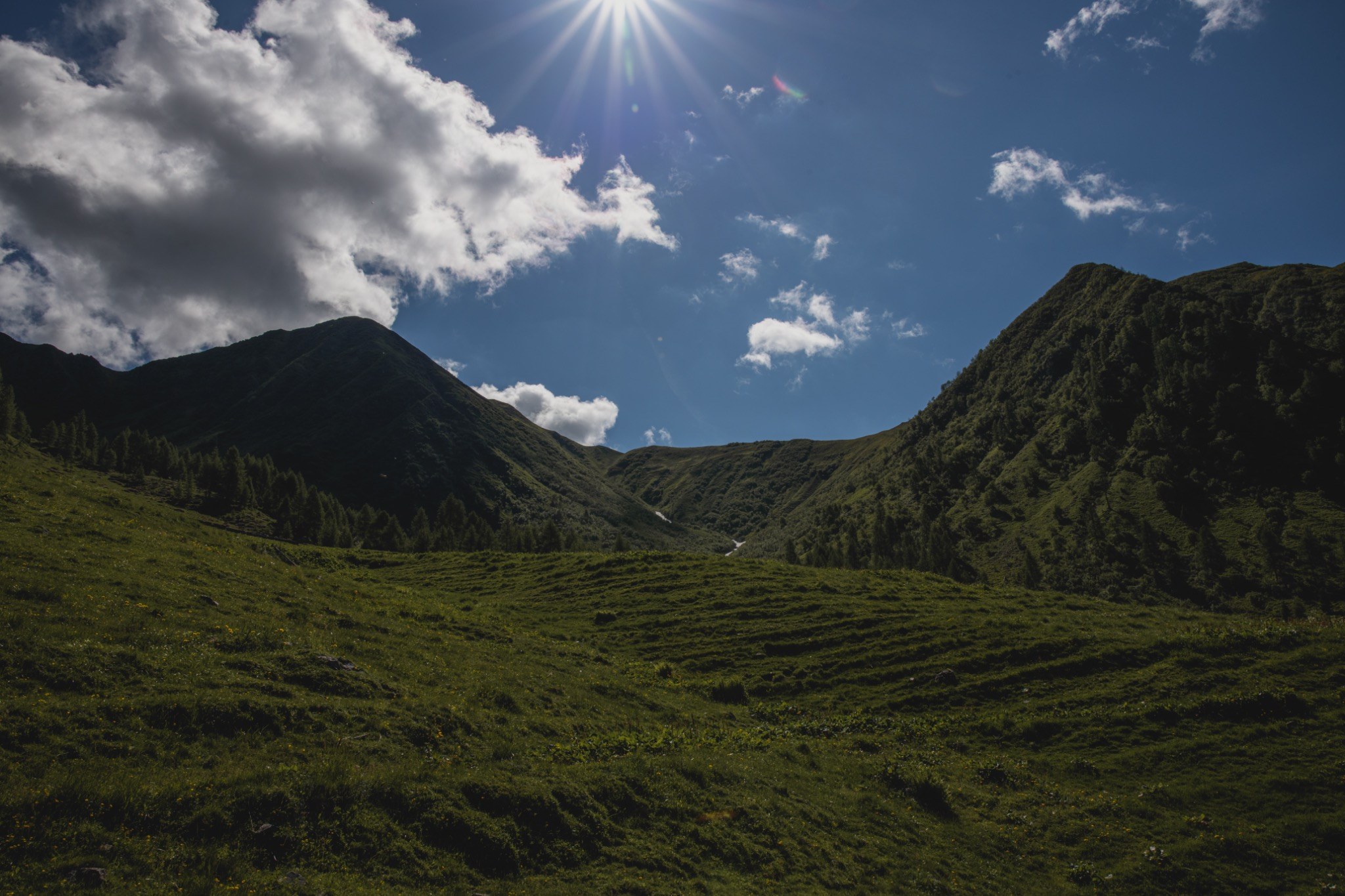 Sunlit mountain valley around Morareto