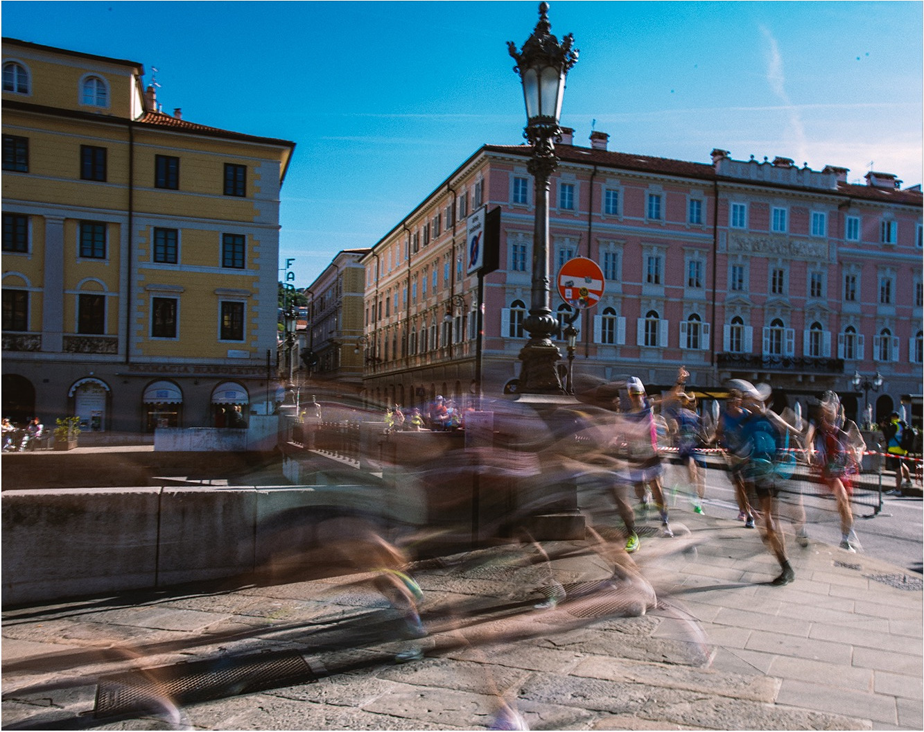 Runners moving through a city with motion blur