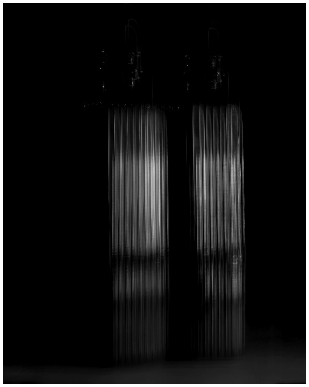 Abstract black and white still life of two ribbed glass vessels